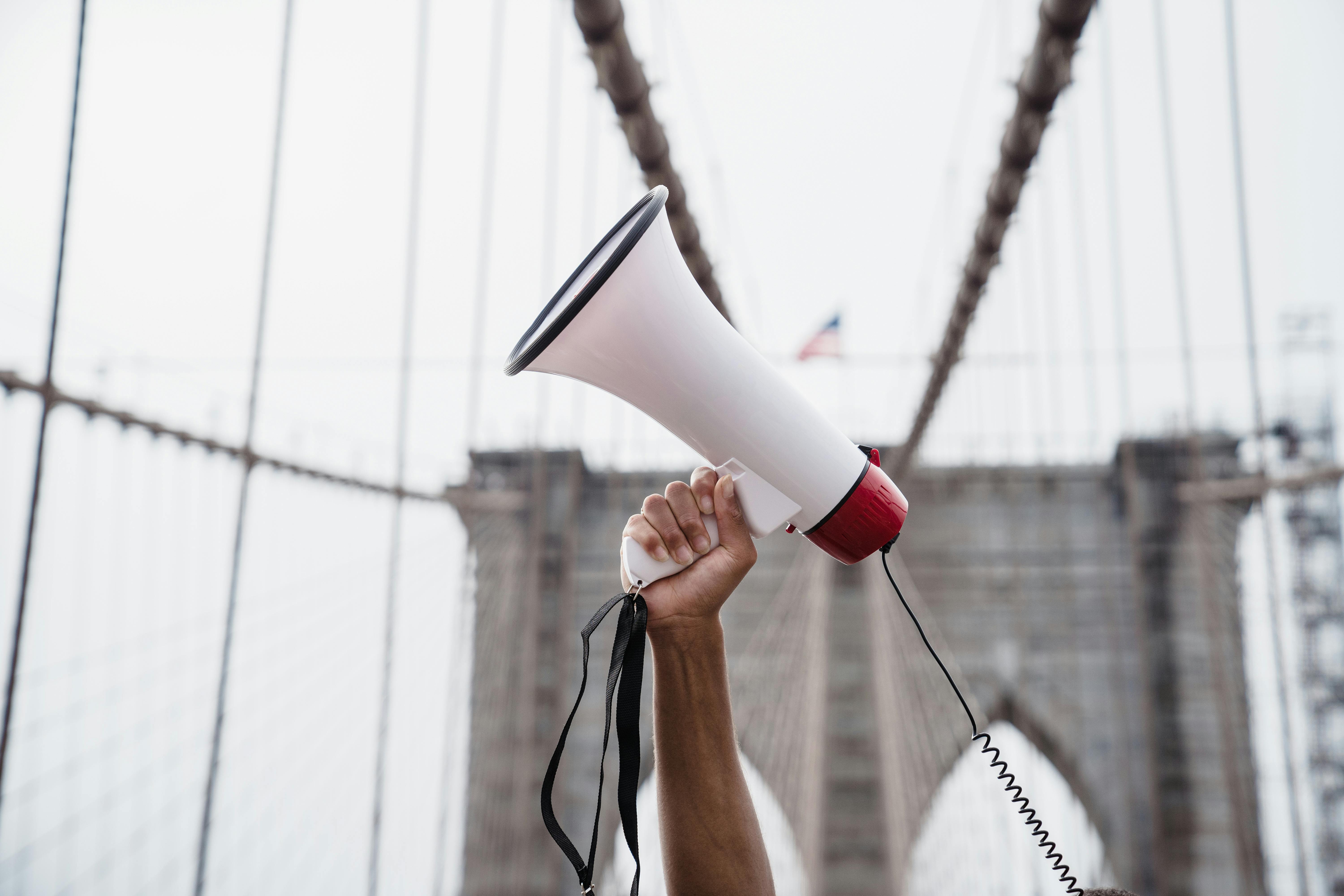 close up of hand with megaphone on demonstration