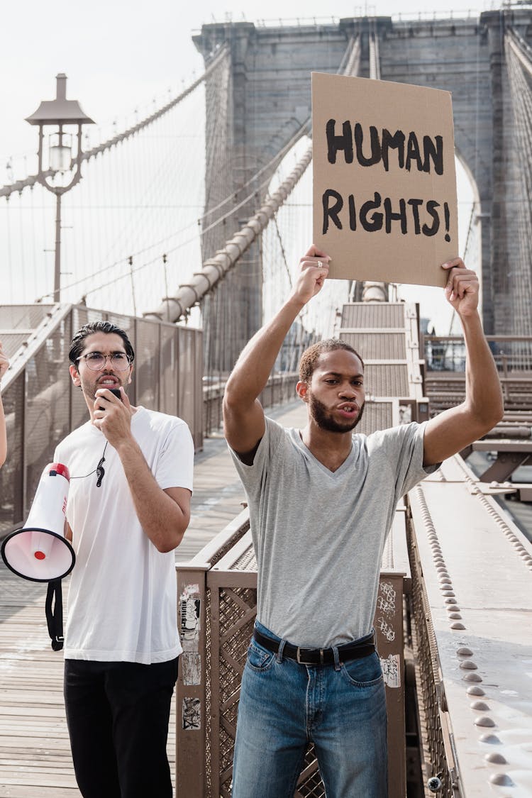 Man Holding A Cardboard Placard