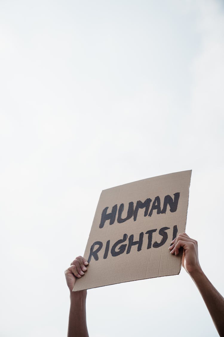 Man Holding A Cardboard Placard