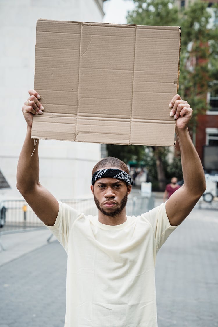 Man With Mockup Placard On Street Demonstration