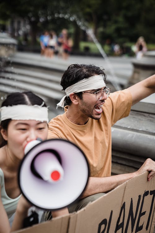 People with Megaphones and Placards on Street Demonstration