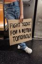 Person holding Cardboard Placard
