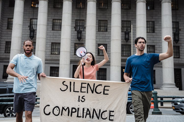 A Group Of People Protesting On The Street