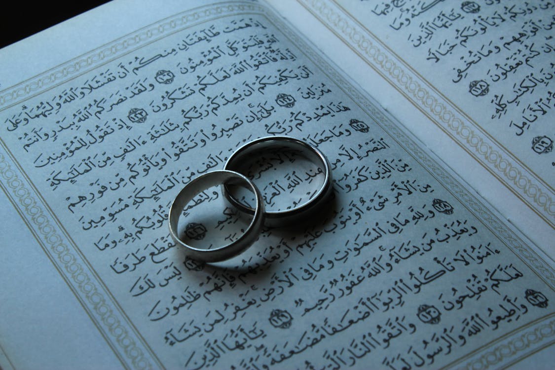 A Silver Rings on Quran Book · Free Stock Photo