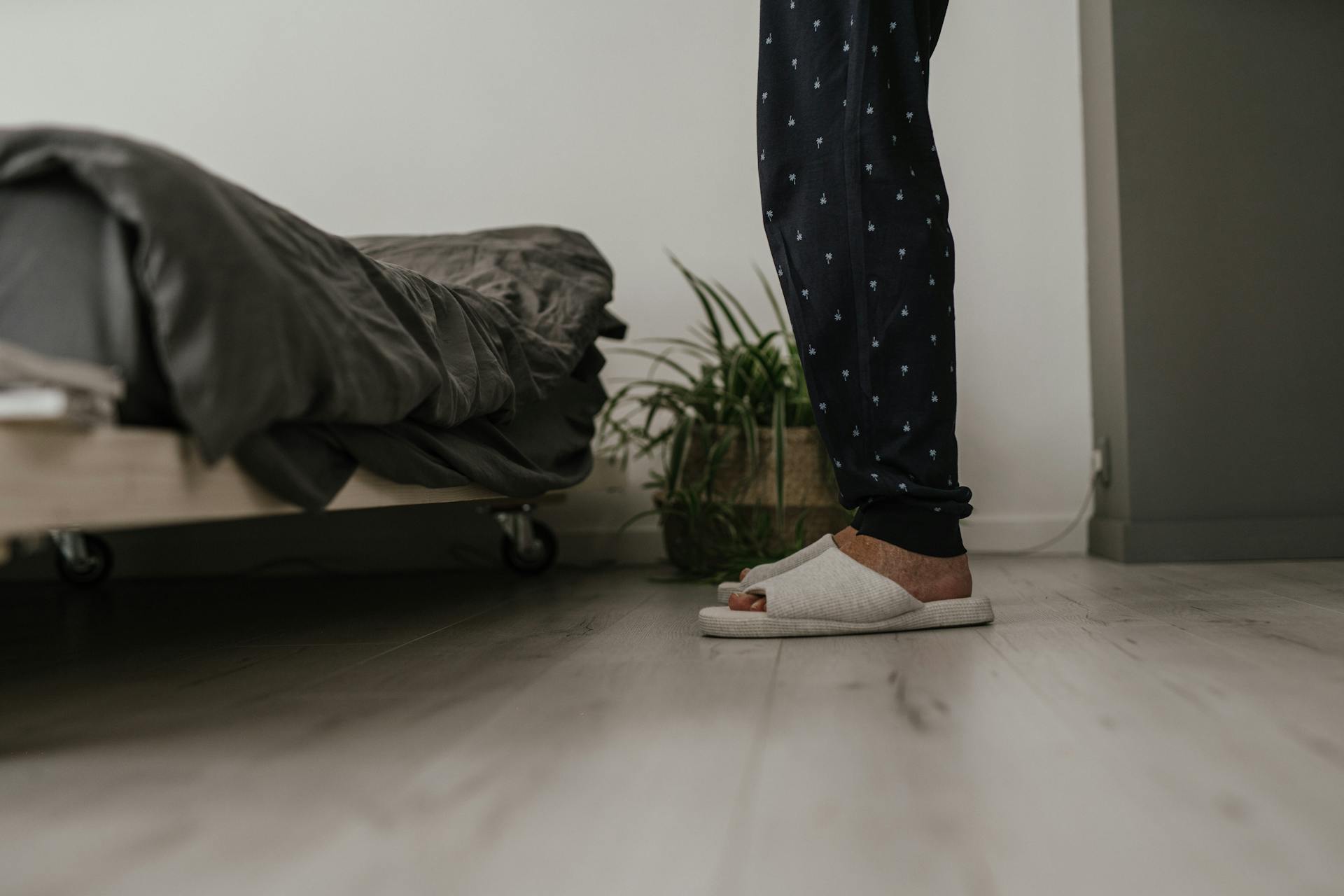 A Person in Black Pants Standing on the Floor