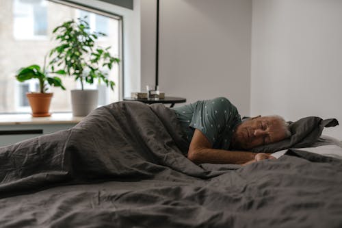 Free An Elderly Man Sleeping on Bed Stock Photo