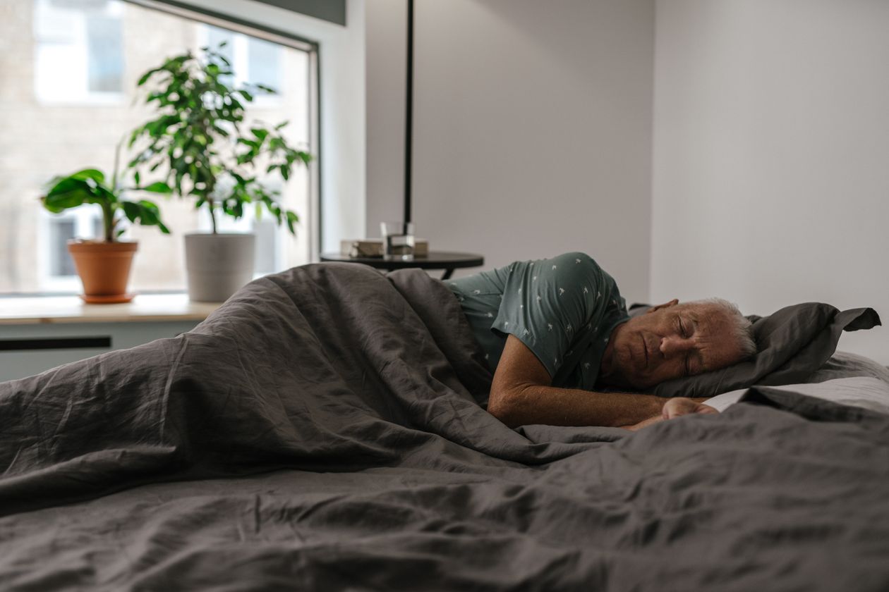 An Elderly Man Sleeping on Bed