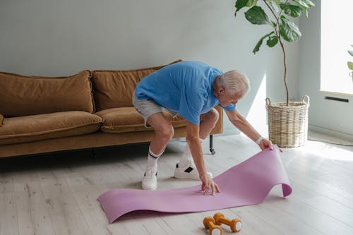 A Man Setting Up His Yoga Mat