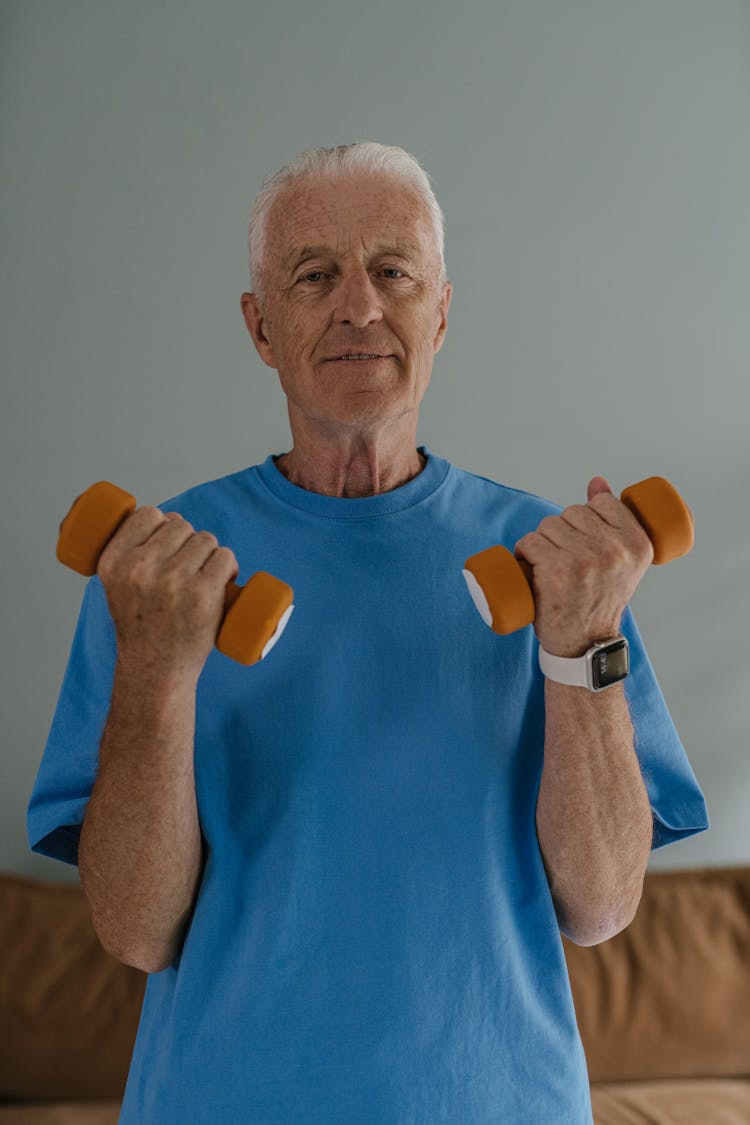 Man In Blue Crew Neck Shirt Holding Dumbbells