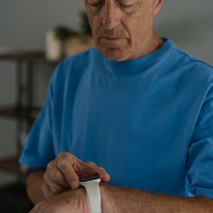 Elderly person wearing health band