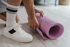 Rolling a yoga mat — SHVETS production on Pexels