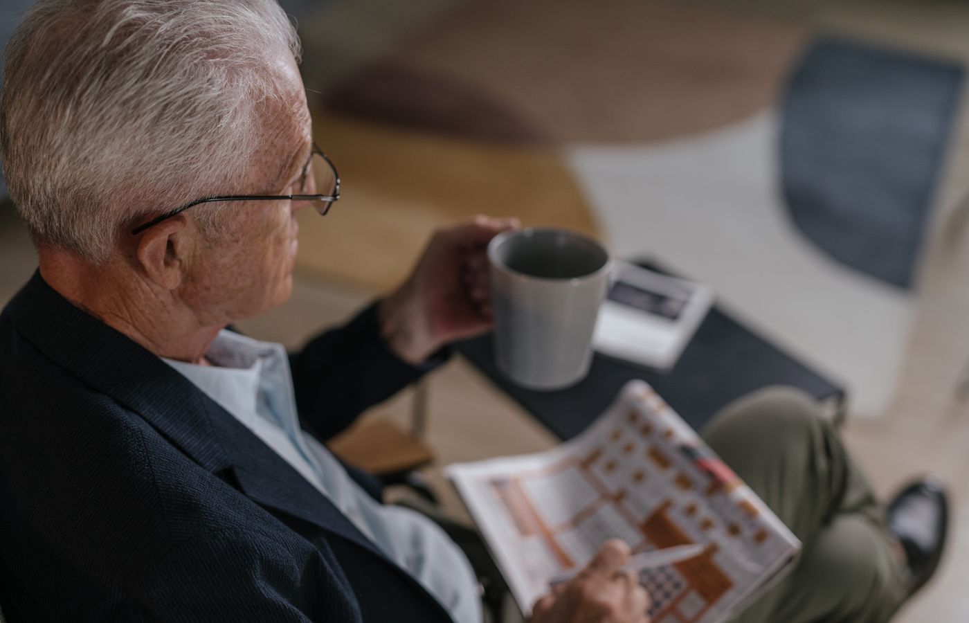 An older adult calmly having morning coffee with an alert system available.