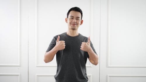 Man in Gray Crew Neck Shirt with his Thumbs Up 