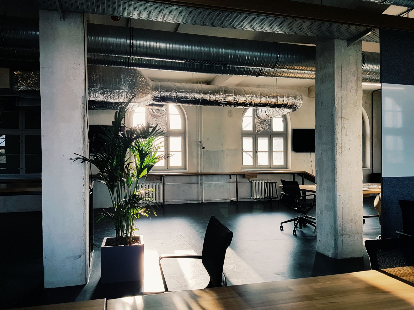 Bright modern office interior with industrial design elements and natural light through large windows.. pexels, bright, moder