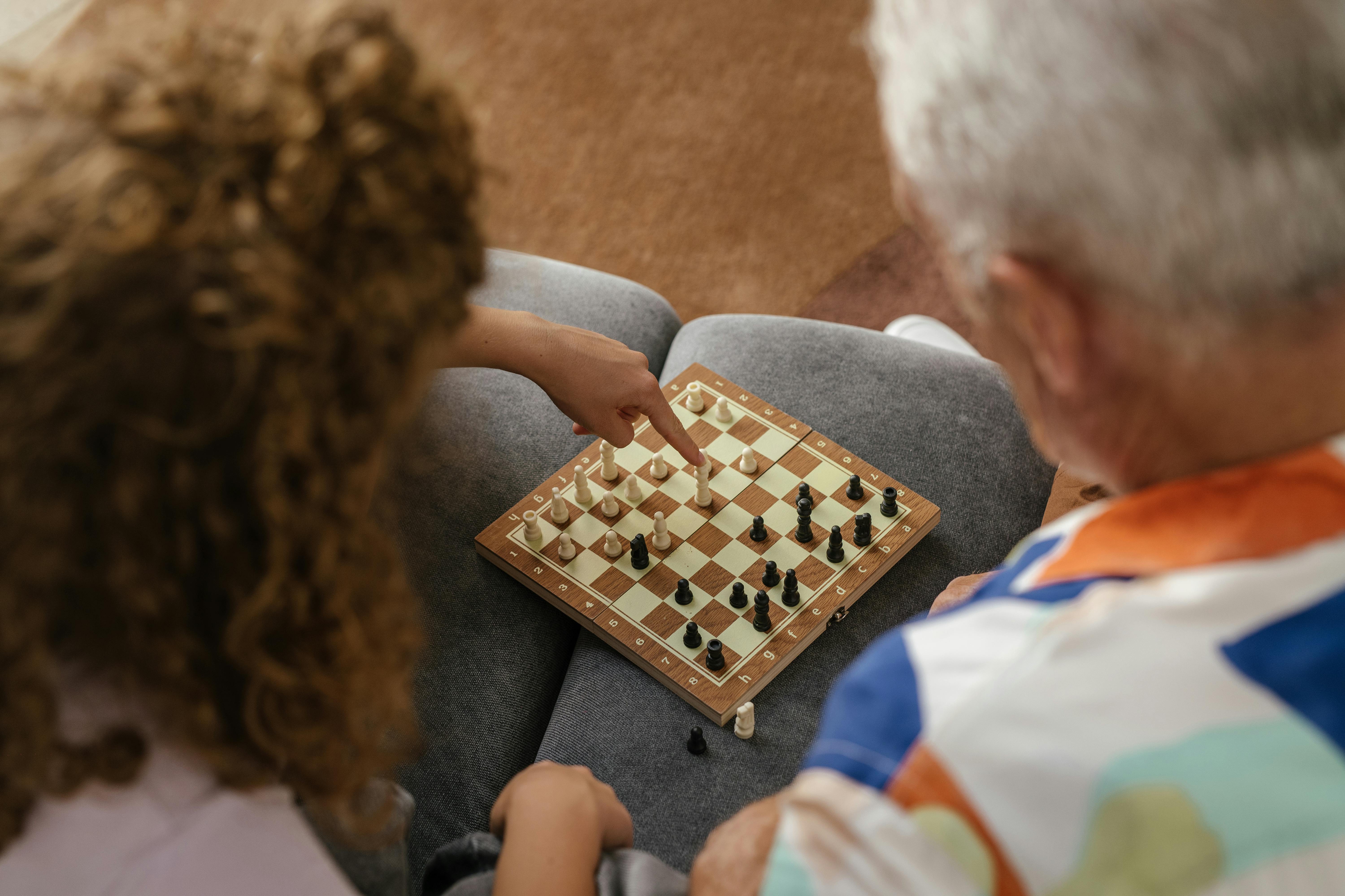 Serious man playing chess in studio · Free Stock Photo