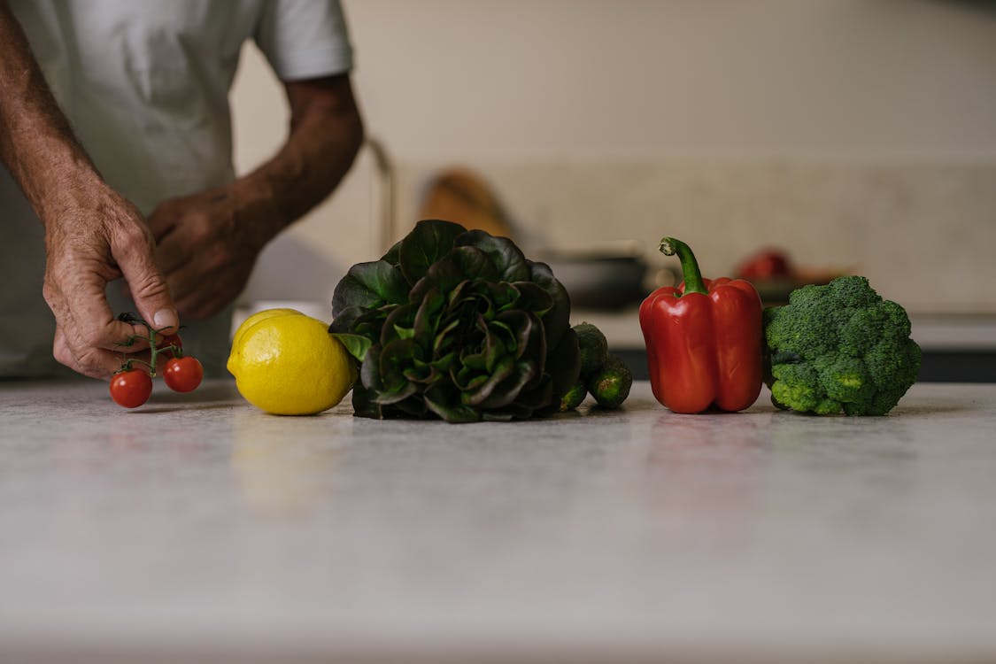 Person Holding Red Tomatoes