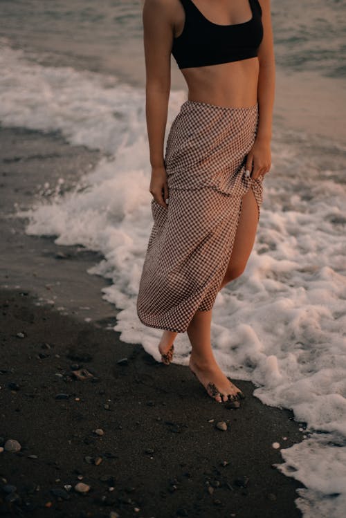 Woman Walking on Shore