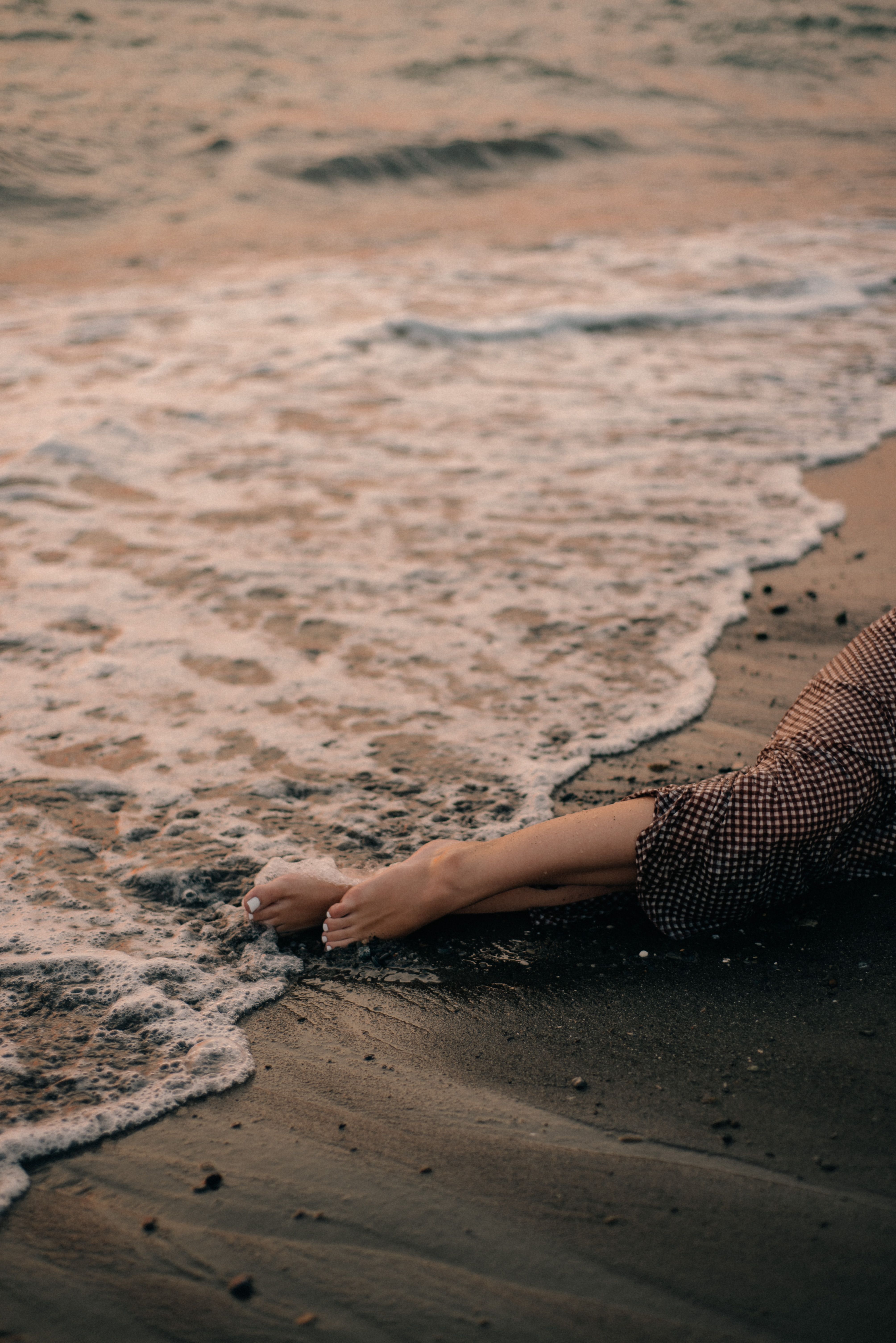 Woman in Polka Dots Skirt Lying on Beach Sand · Free Stock Photo