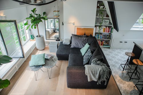 Black Sofa With Throw Pillows near Window