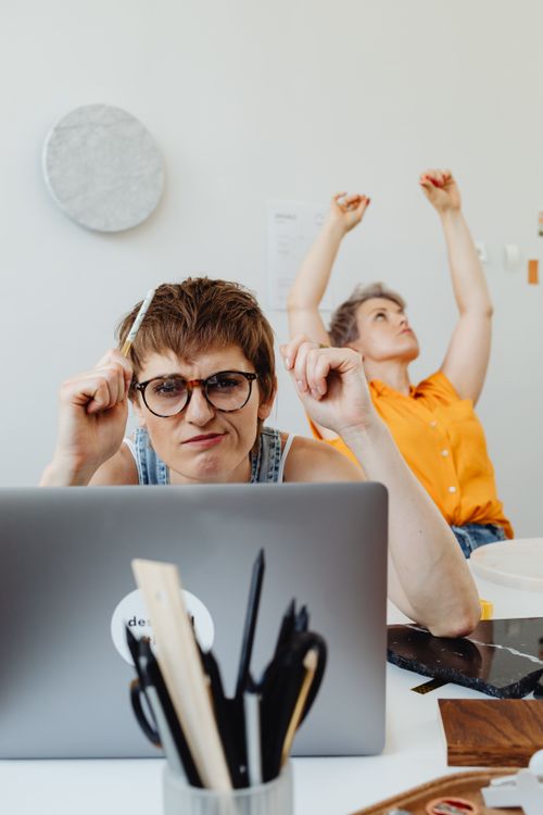 Free Two women working together on a project indoors, focusing and brainstorming. Stock Photo