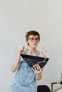 Woman in Blue Denim Button Up Jacket Holding Black Leather Bag
