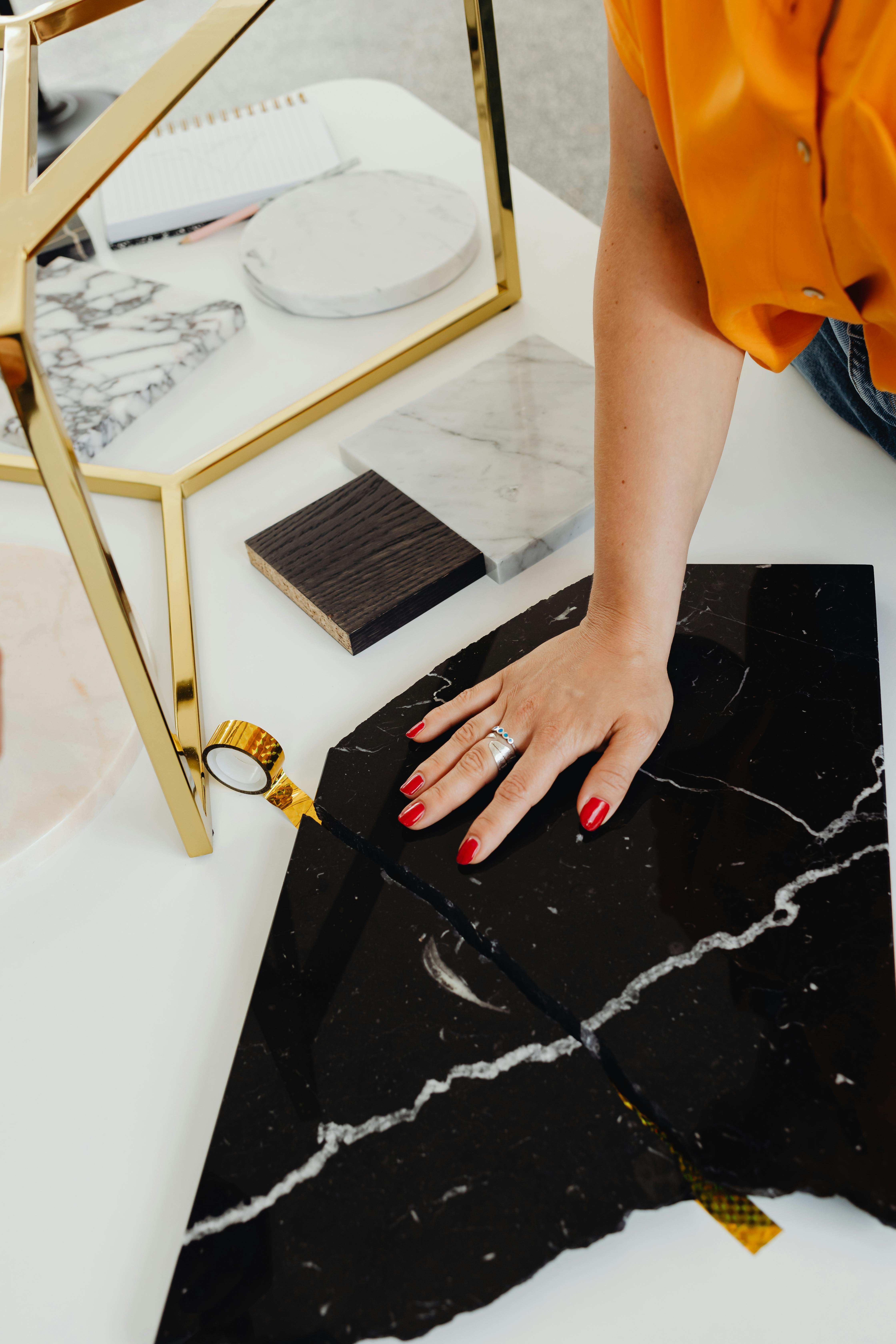 person holding hand on black marble