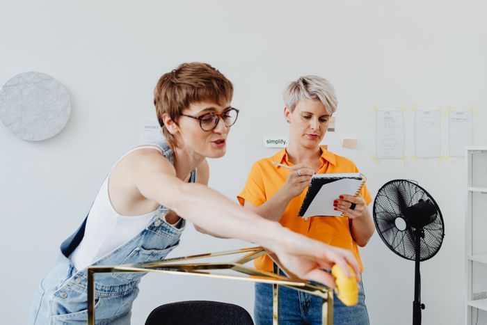 Two designers pinning up a layout — kaboompics.com on Pexels