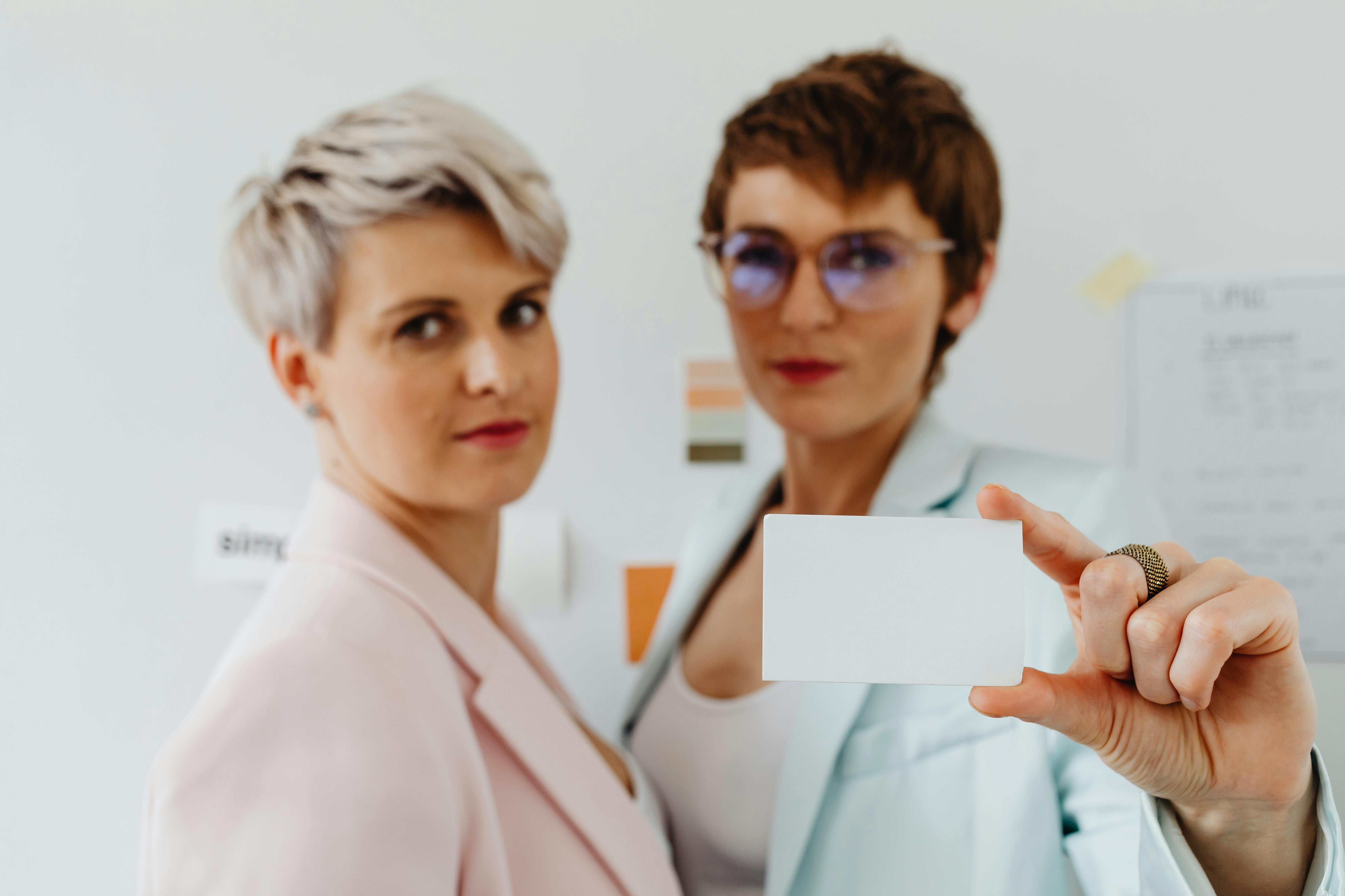 two women with business card