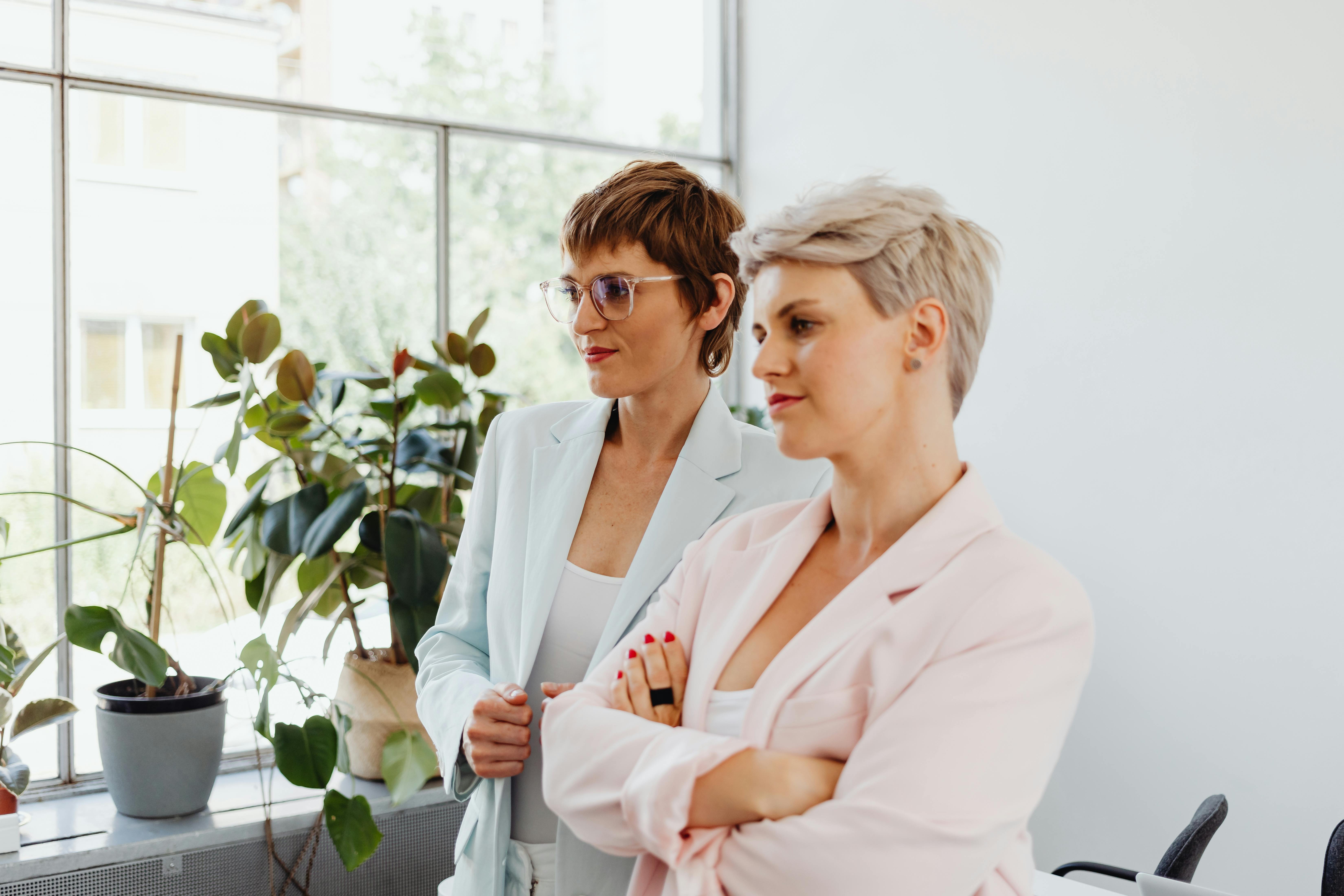 woman in white blazer wearing eyeglasses