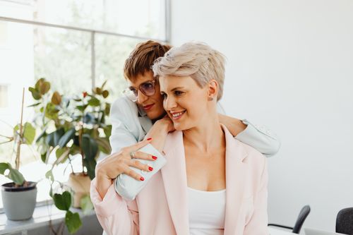 Free Happy couple embracing and smiling in a bright indoor setting, showcasing love and connection. Stock Photo