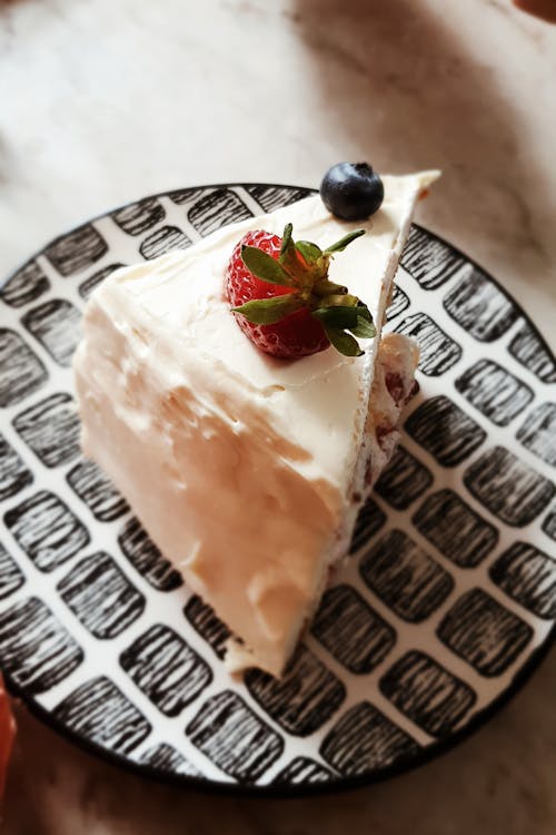 Free Close-Up Photo of a Slice of Cheesecake with Fruits on Top Stock Photo