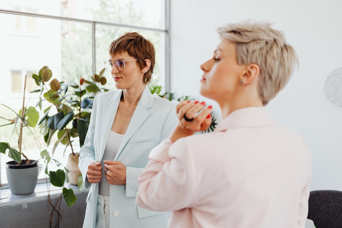 Businesswomen in Pink and White Blazers with Short Hair · Free Stock Photo