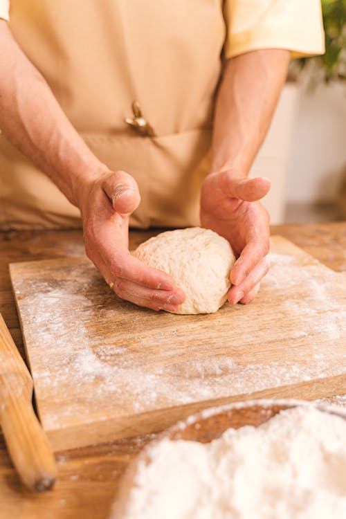 Free Selective Focus Photo of Dough Between a Person's Hands Stock Photo