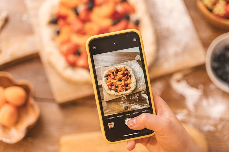 Person Taking Picture With Cellphone Of Pie