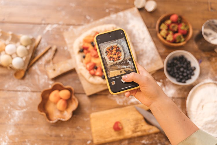 Person Taking Picture Of A Pie With A Smartphone