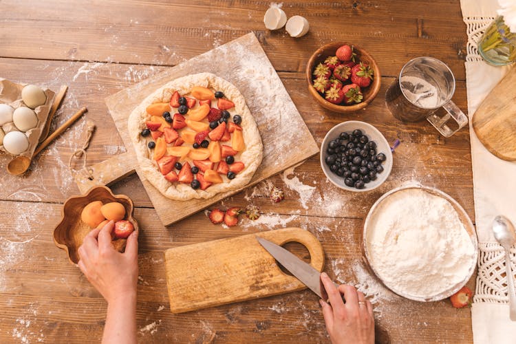 Hands With Knife Making Cake