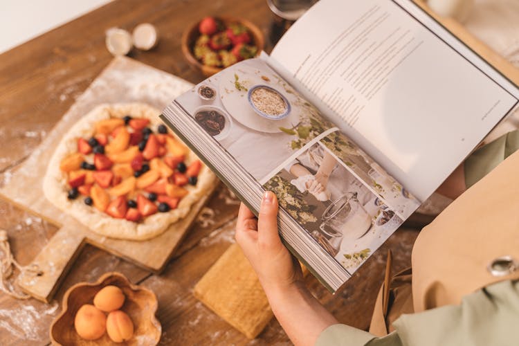 Person Holding Cookbook