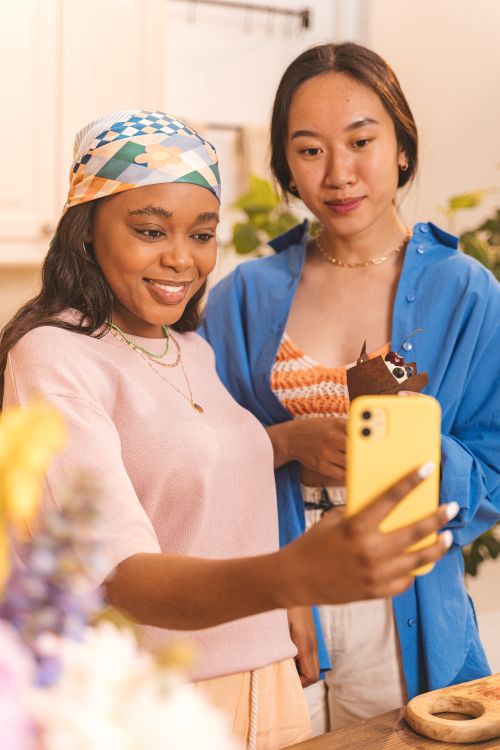 Free Two women smiling while taking a selfie together, showcasing friendship and joy. Stock Photo