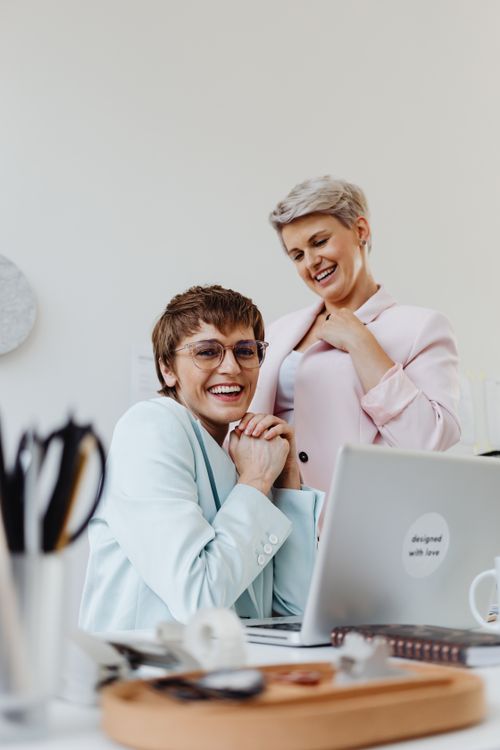 Free Happy businesswomen in conversation at a modern office, showcasing teamwork and confidence. Stock Photo