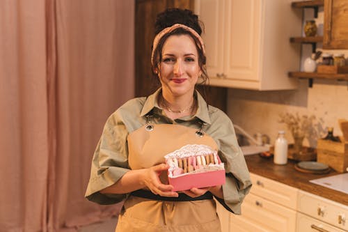 A Woman Holding a Box of Macaroons