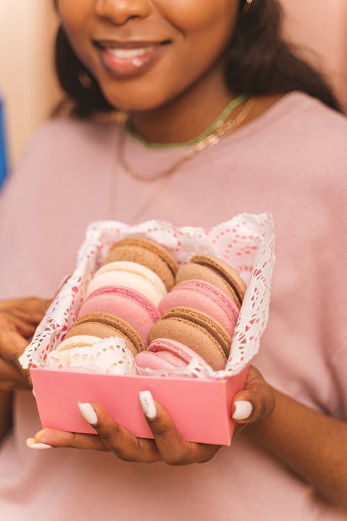 A Woman Holding a Box of Macaroons