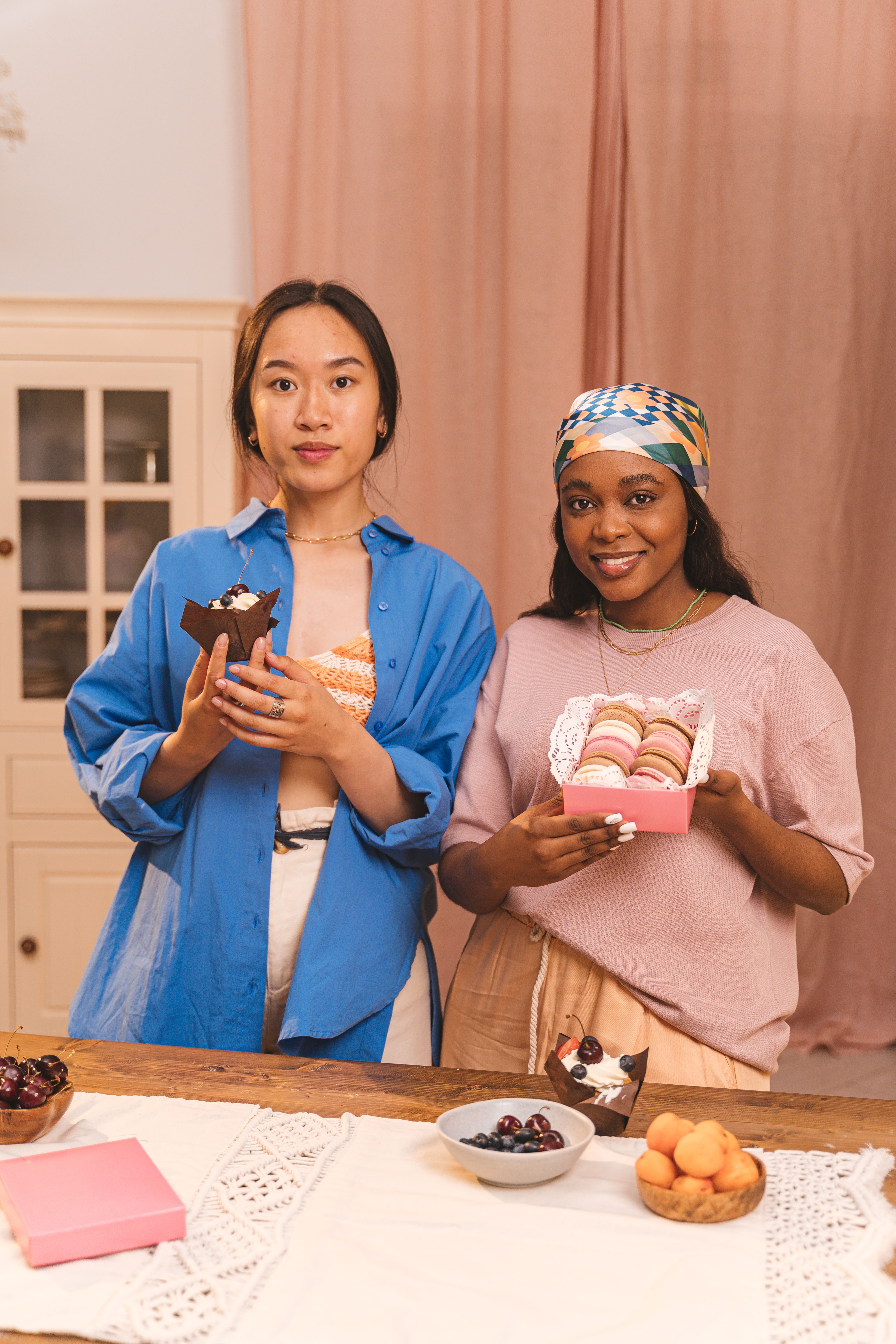 Woman in Blue Long Sleeve Shirt Holding Brown Cupcake · Free Stock Photo