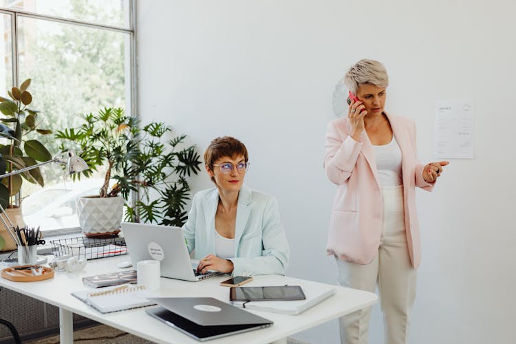 Women In Business Attires Working In An Office