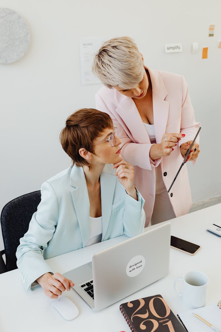 Women In Business Suits Collaborating At Work