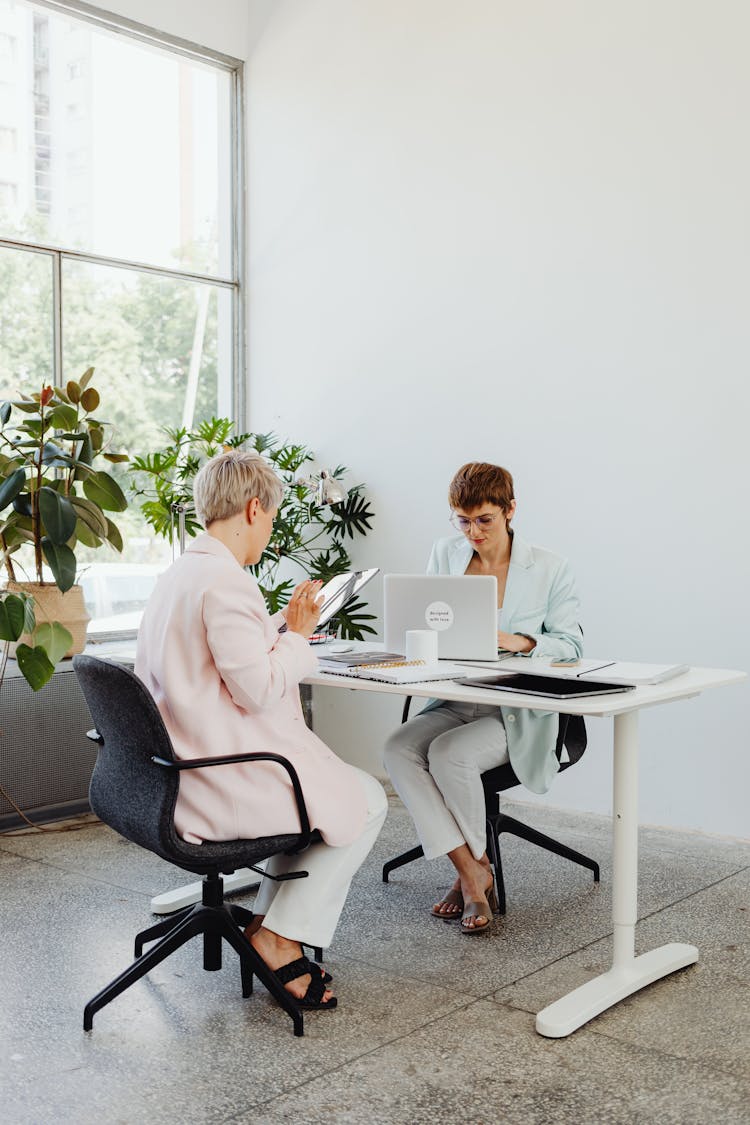 Two Women Working In The Office Together 