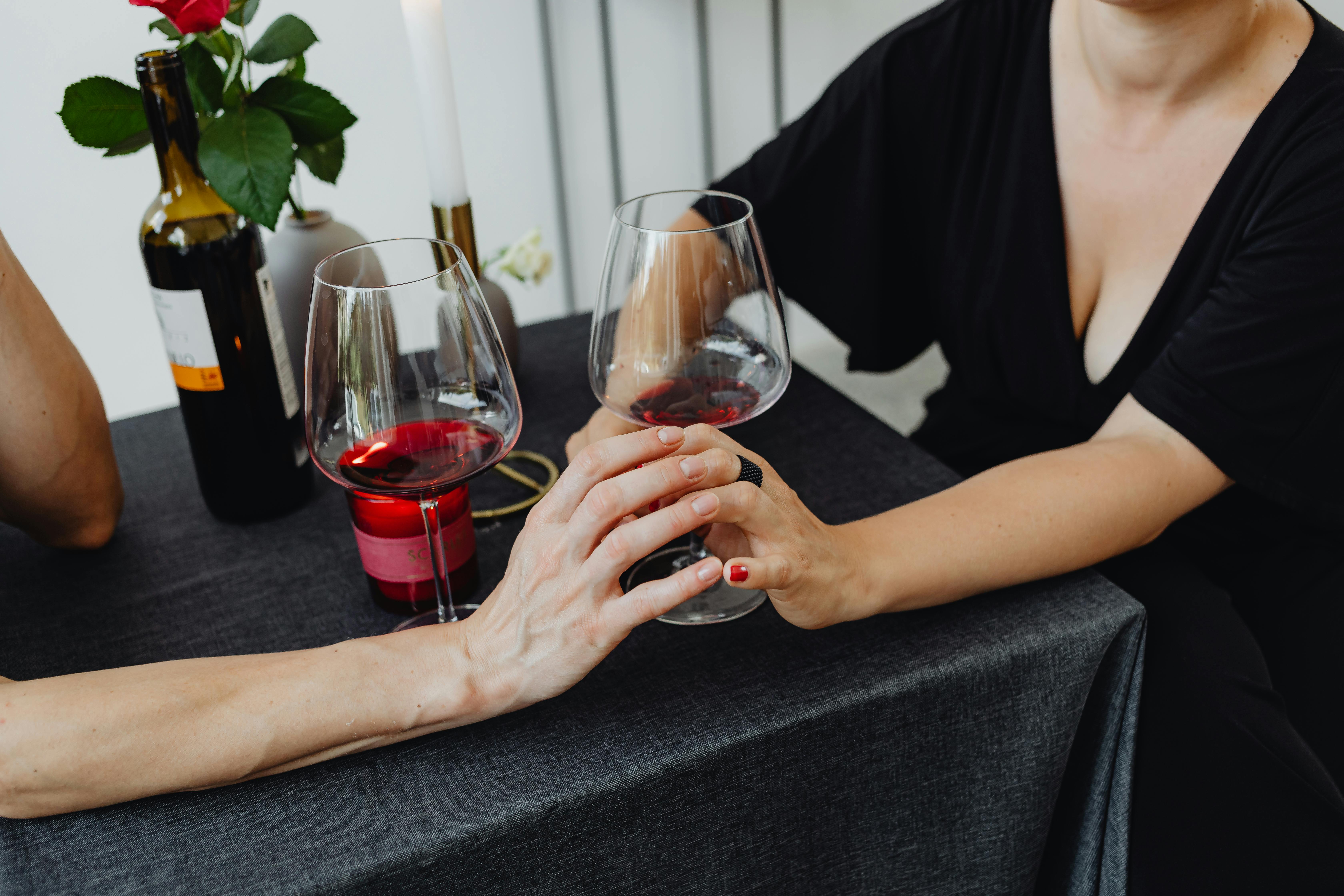 women holding hands on date in restaurant