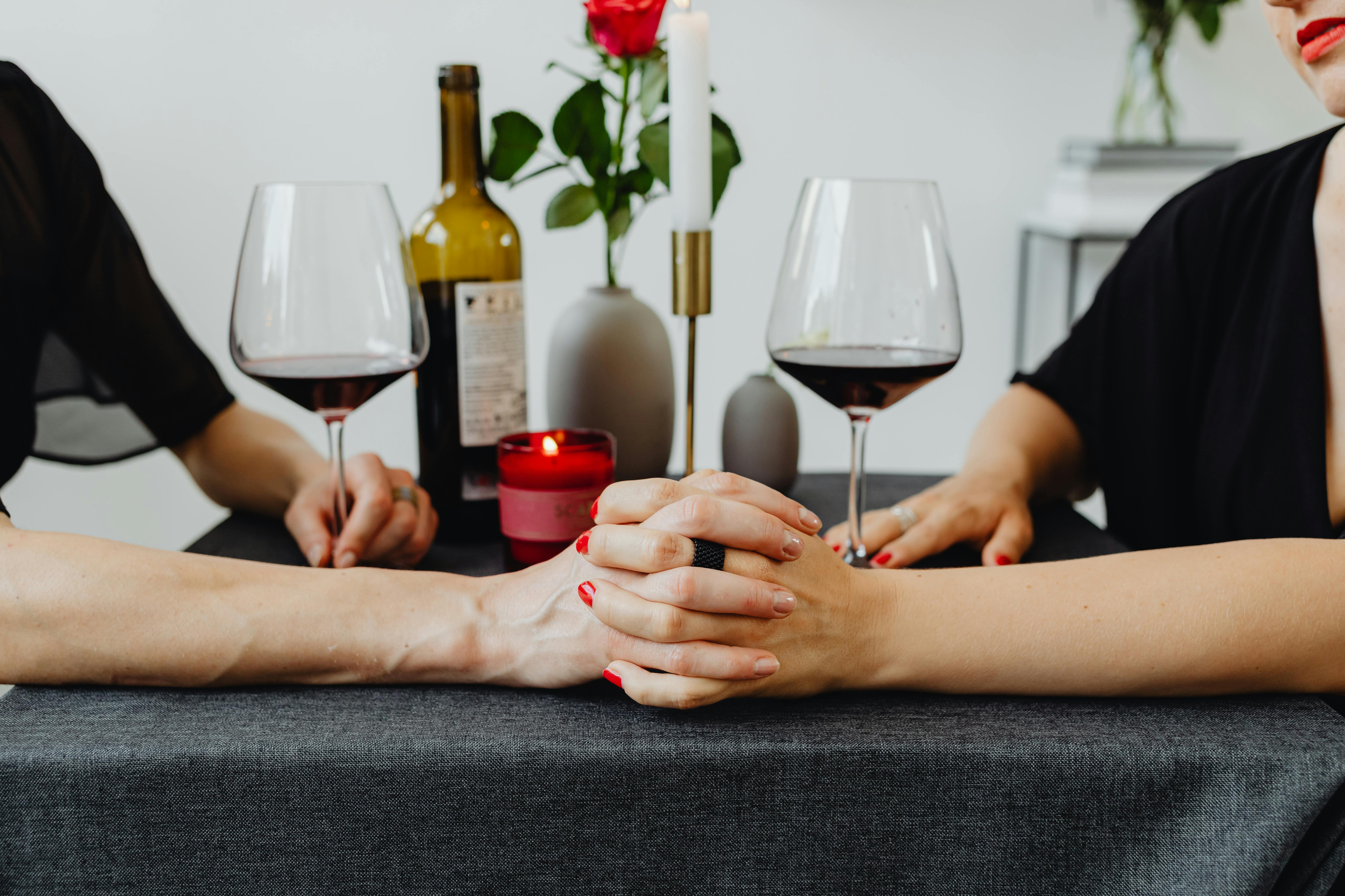 person holding clear wine glass