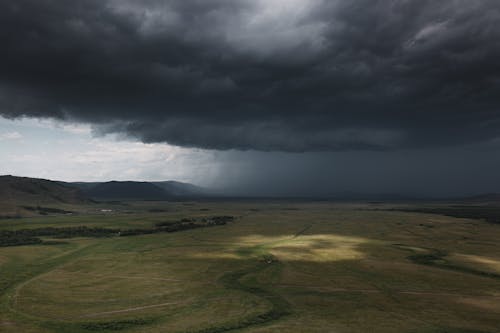 Free Dark Heavy Clouds over the Grass Land Stock Photo