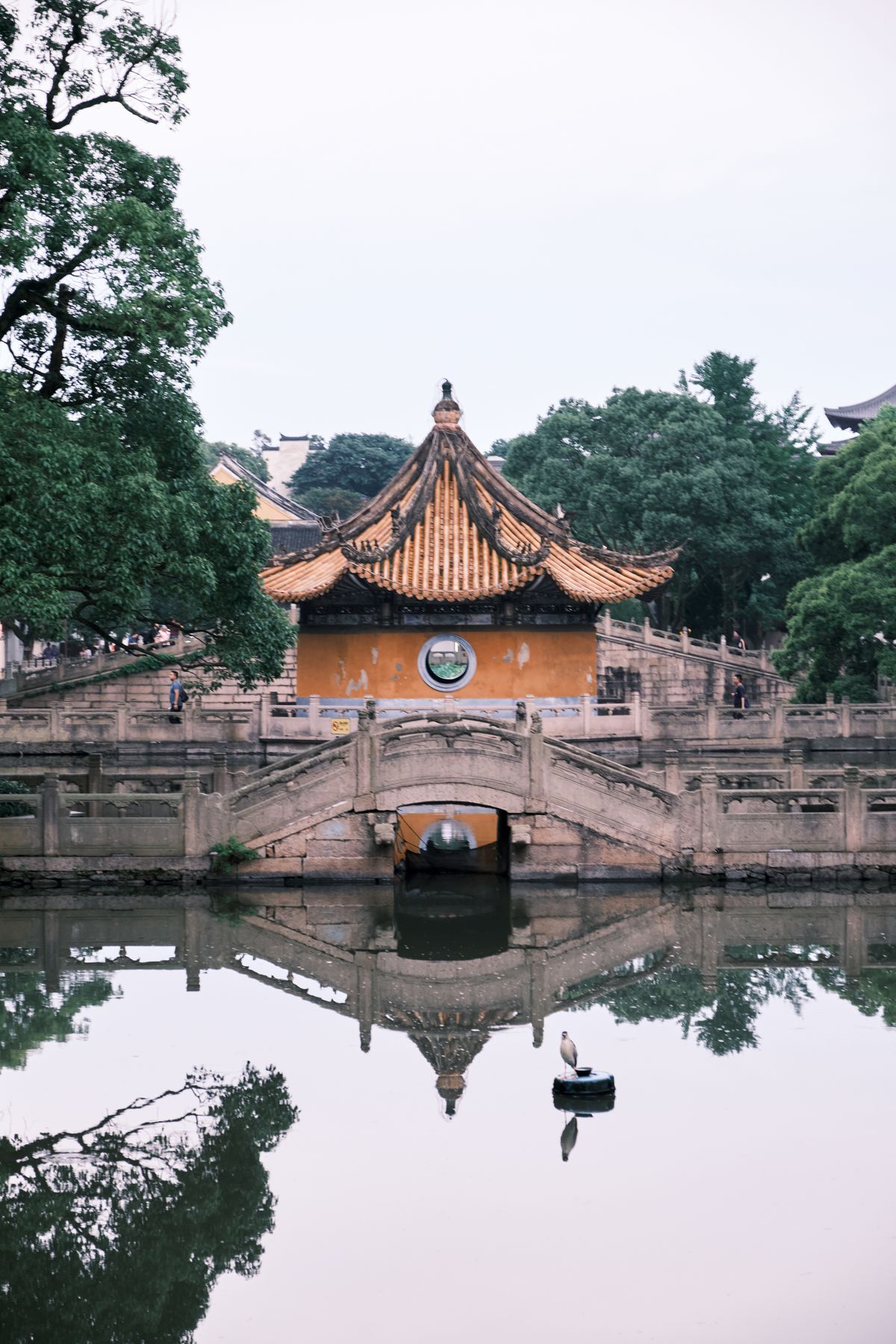 A traditional Chinese temple with a serene reflecting pond
