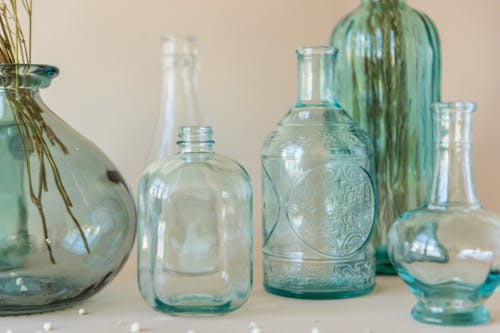 Clear Glass Bottles on the Table